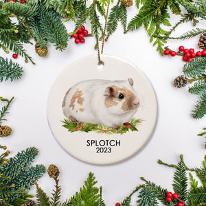 A special ornament for a special guinea pig. This is ceramic and includes a name and date for a  beige and white guinea pig