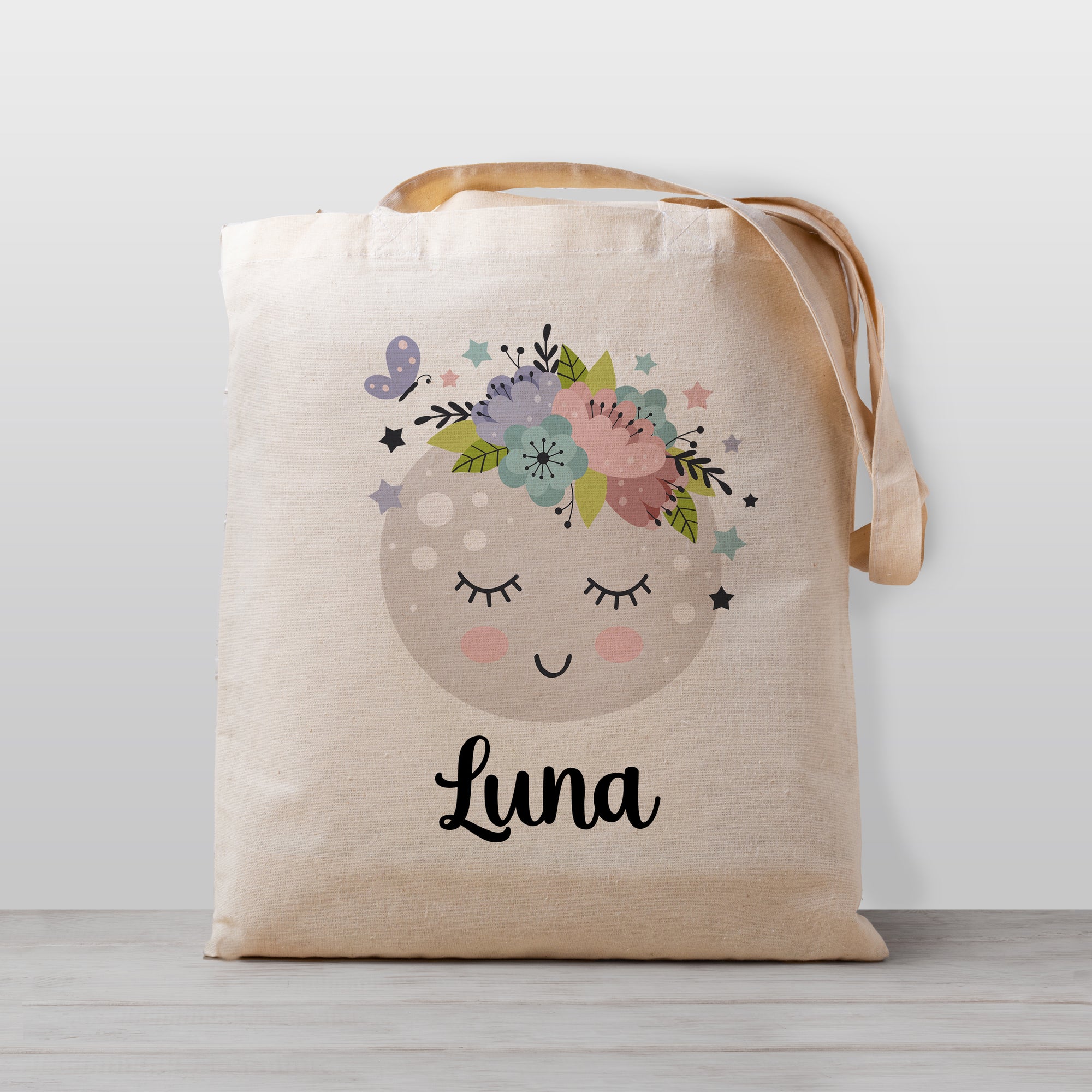 Moon Tote bag for kids, Moon has a cute kawaii face with flowers and stars. Personalized with your child&#39;s name. 100% natural cotton canvas. Printed with child-safe inks in our Nashville studio.
