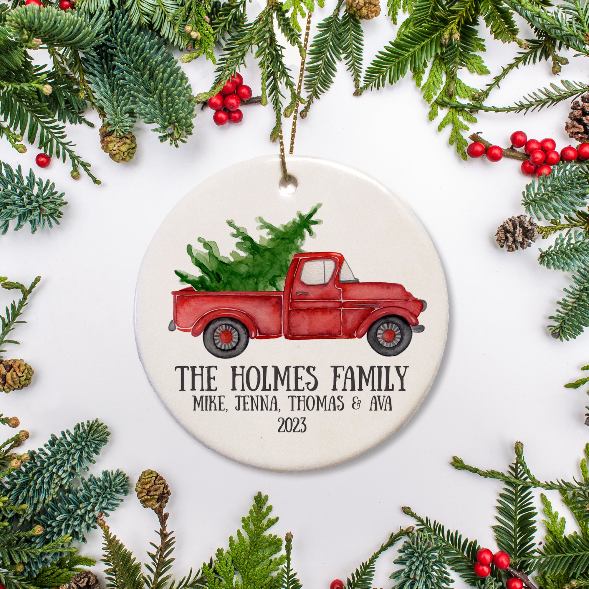 Personalized Christmas Ornament, Red vintage pick up truck carrying a Christmas tree in the bed - Personalize this Christmas Ornament with the family name and year. Include names of family just the name | PIPSY.COM