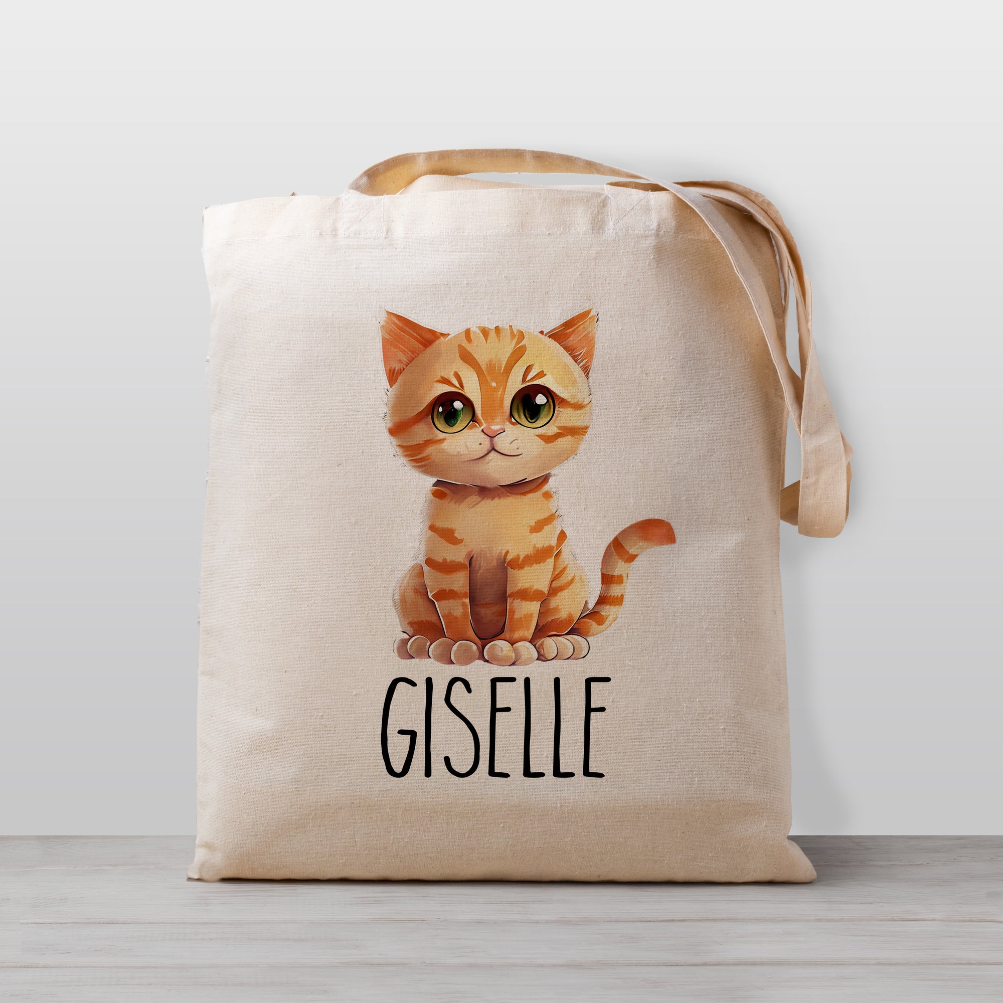 A personalized tote bag featuring a cute orange ginger tabby cat. 100% natural cotton canvas, sized for preschool, daycare, and kindergarten