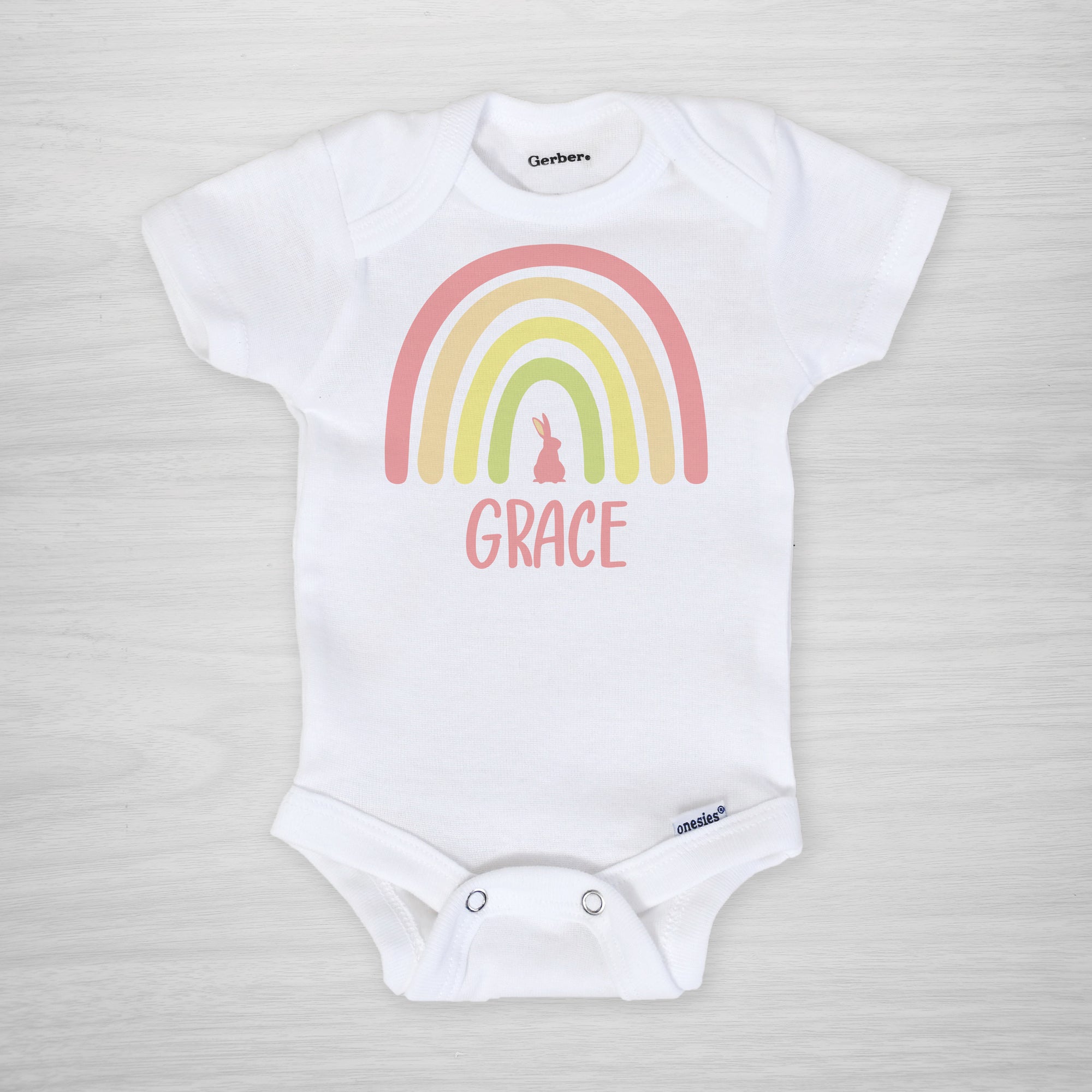 Personalized Easter Onesie, featuring a boho Easter rainbow with a bunny, pink, short sleeved