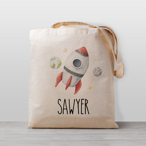 Personalized kids tote bag, a rocket ship in space with a view of the moon and earth