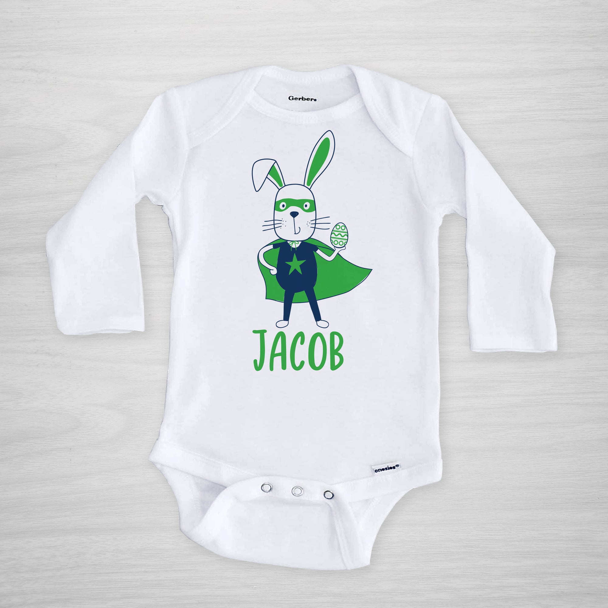 Superhero Easter Bunny with a cape, mask, and egg on this personalized Gerber Onesie®, long sleeved blue