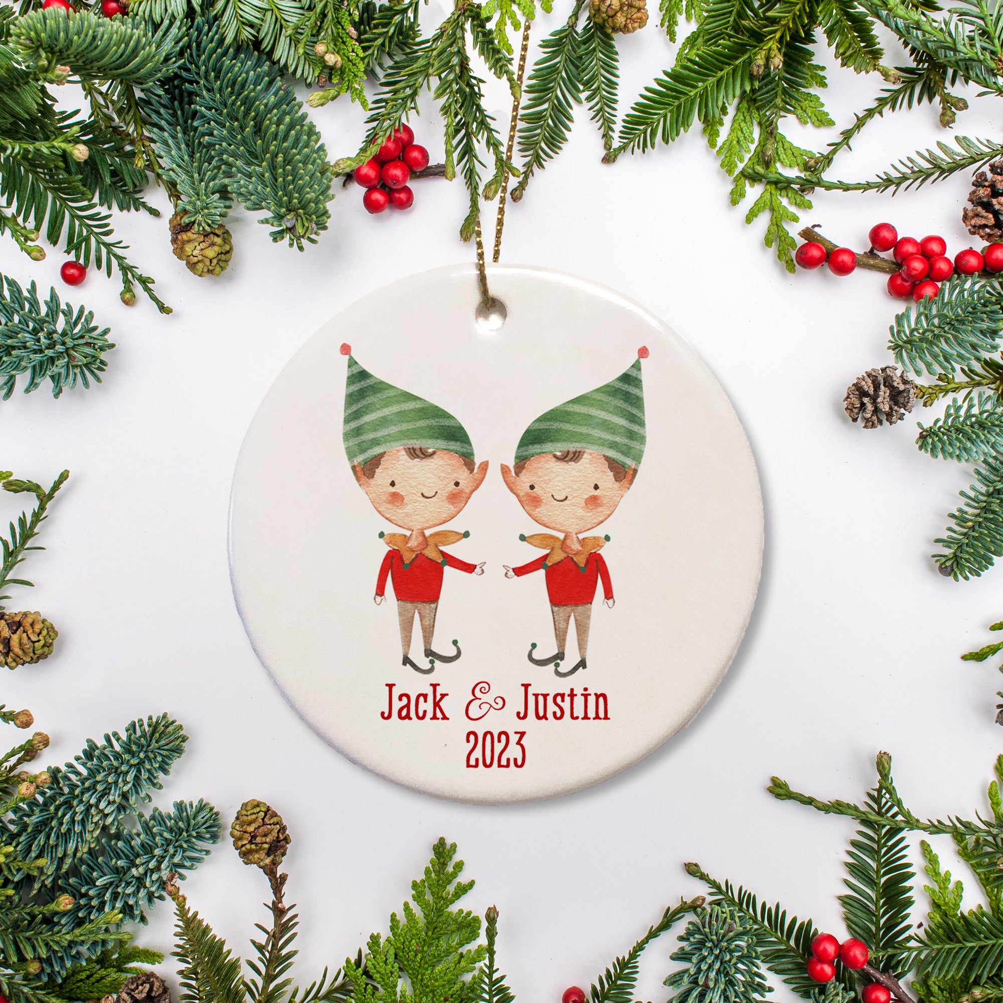 A sweet elf picture of two boys on a ceramic ornament with the name and the date.