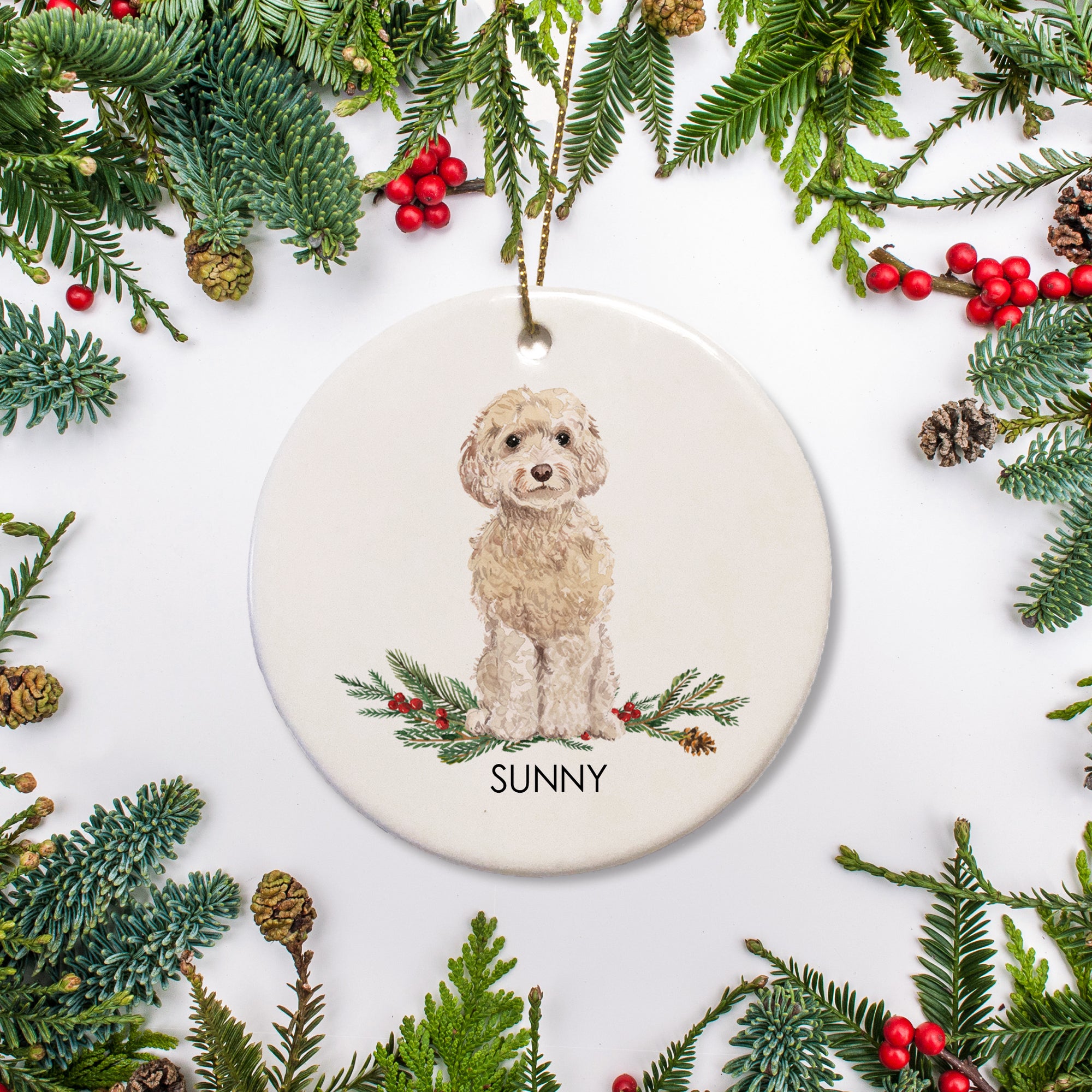 Cockapoo Christmas ornament featuring a champagne colored doodle sitting on a bed of holly. The ceramic ornament is personalized with your dog's name and the year