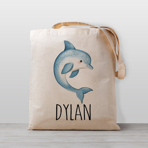 Tote bag with a dolphin design and the your child's name on a light weight beige tote bag