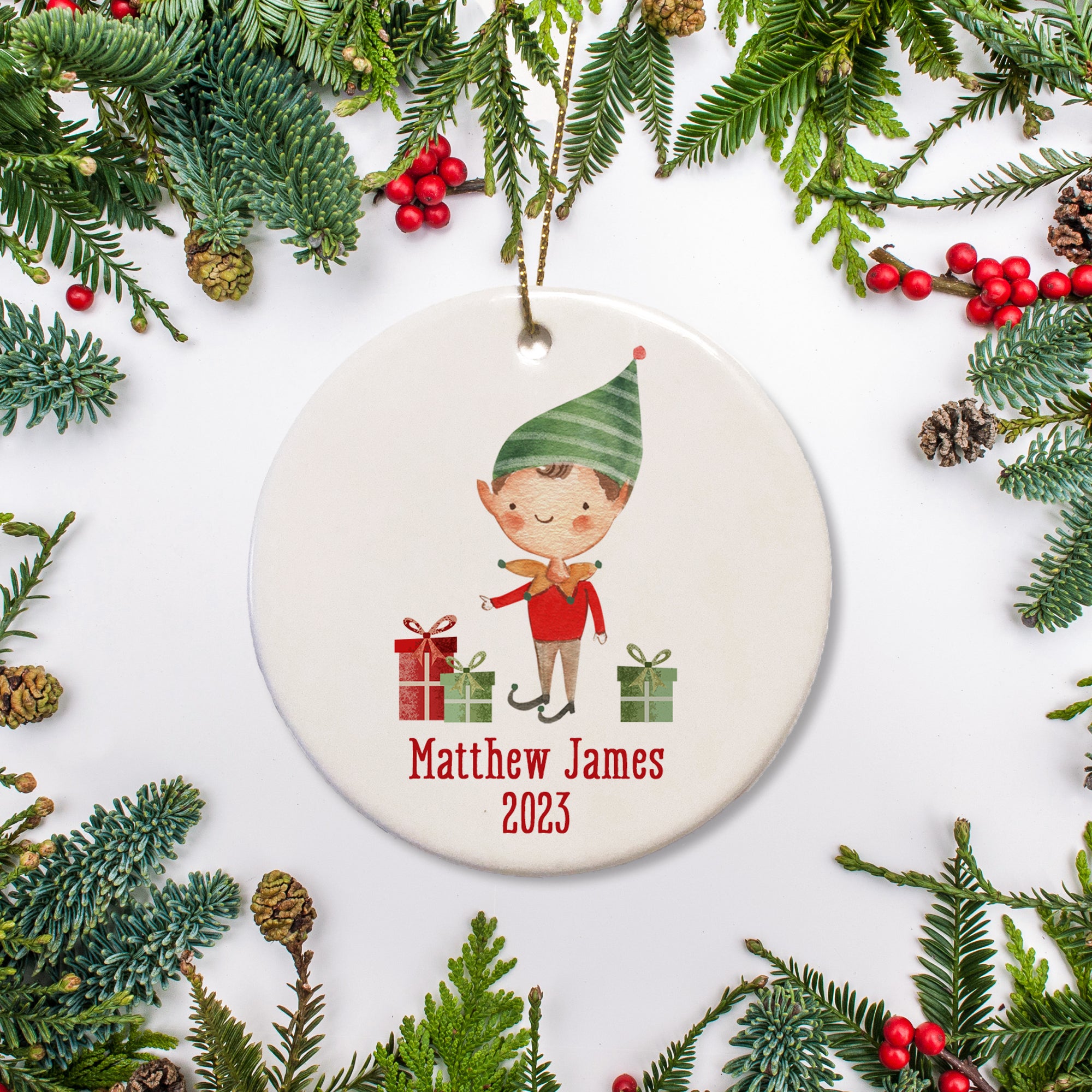 A sweet boy elf picture on a ceramic ornament with the name and the date.