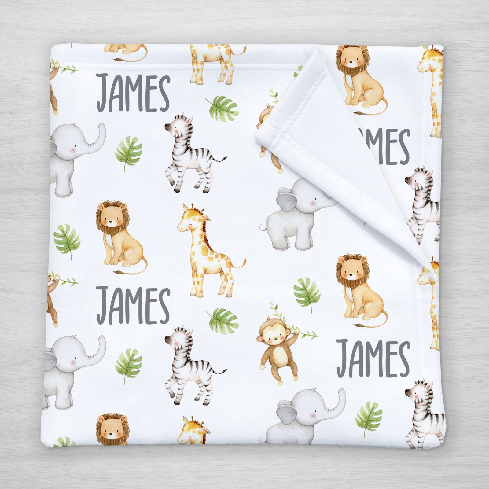 Blanket with jungle animal pattern and your child's name on a white fleece fabric