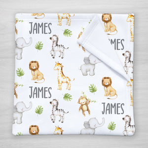 Blanket with jungle animal pattern and your child's name on a white fleece fabric