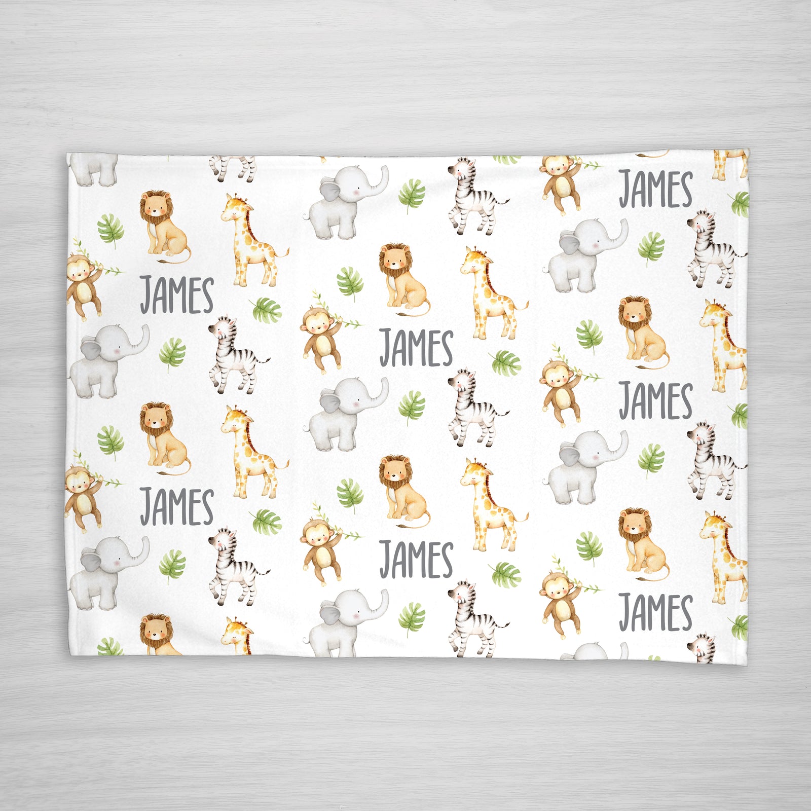 Blanket with jungle animal pattern and your child's name on a white fleece fabric