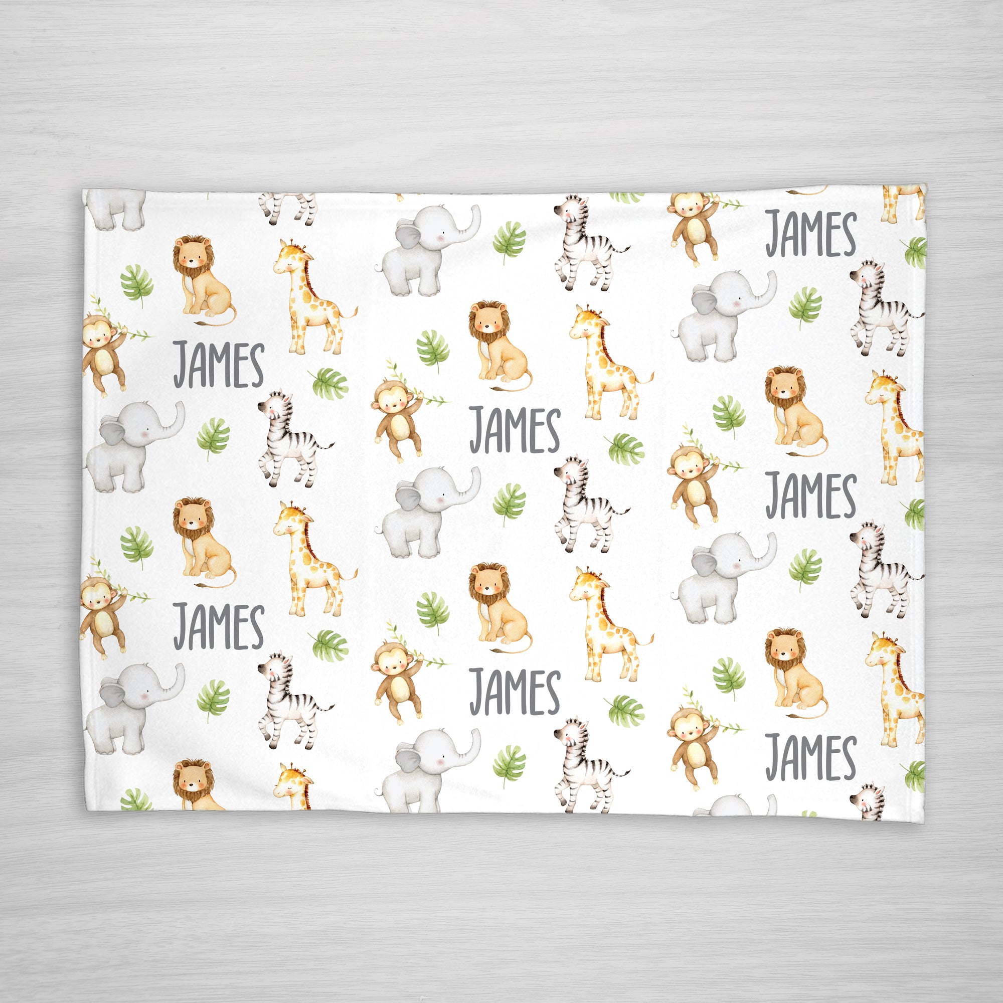 Blanket with jungle animal pattern and your child's name on a white fleece fabric