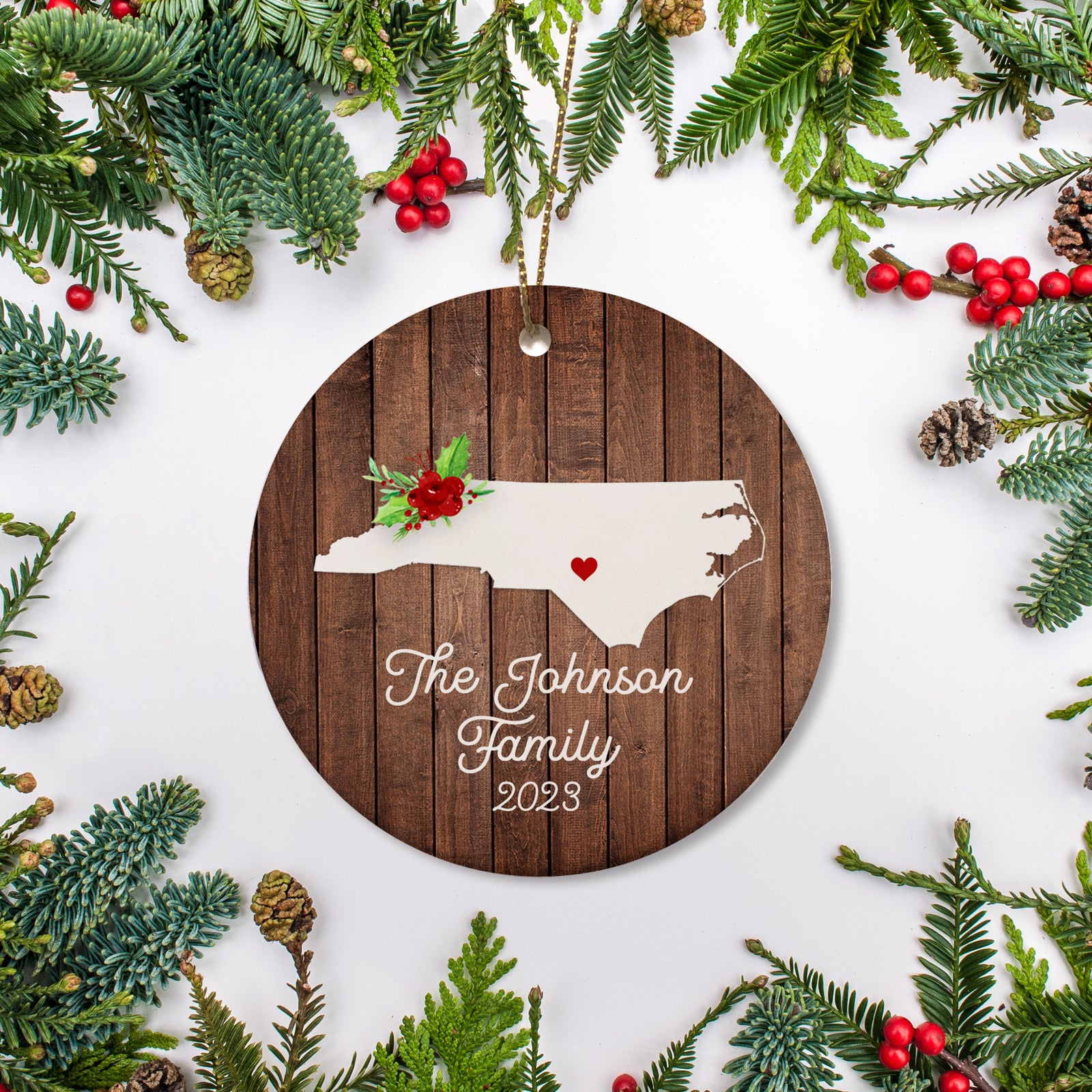 North Carolina state christmas ornament. Personalized with your name, city, and year. Ceramic keepsake ornament with a gold hanging string. Great for a college student, new home owners, just moved, or vacation memory