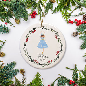 Nutcracker "Clara" ballerina personalized Christmas Ornament surrounded by a simple holiday wreath. Dressed in her blue costume and blue bow. PIPSY.COM