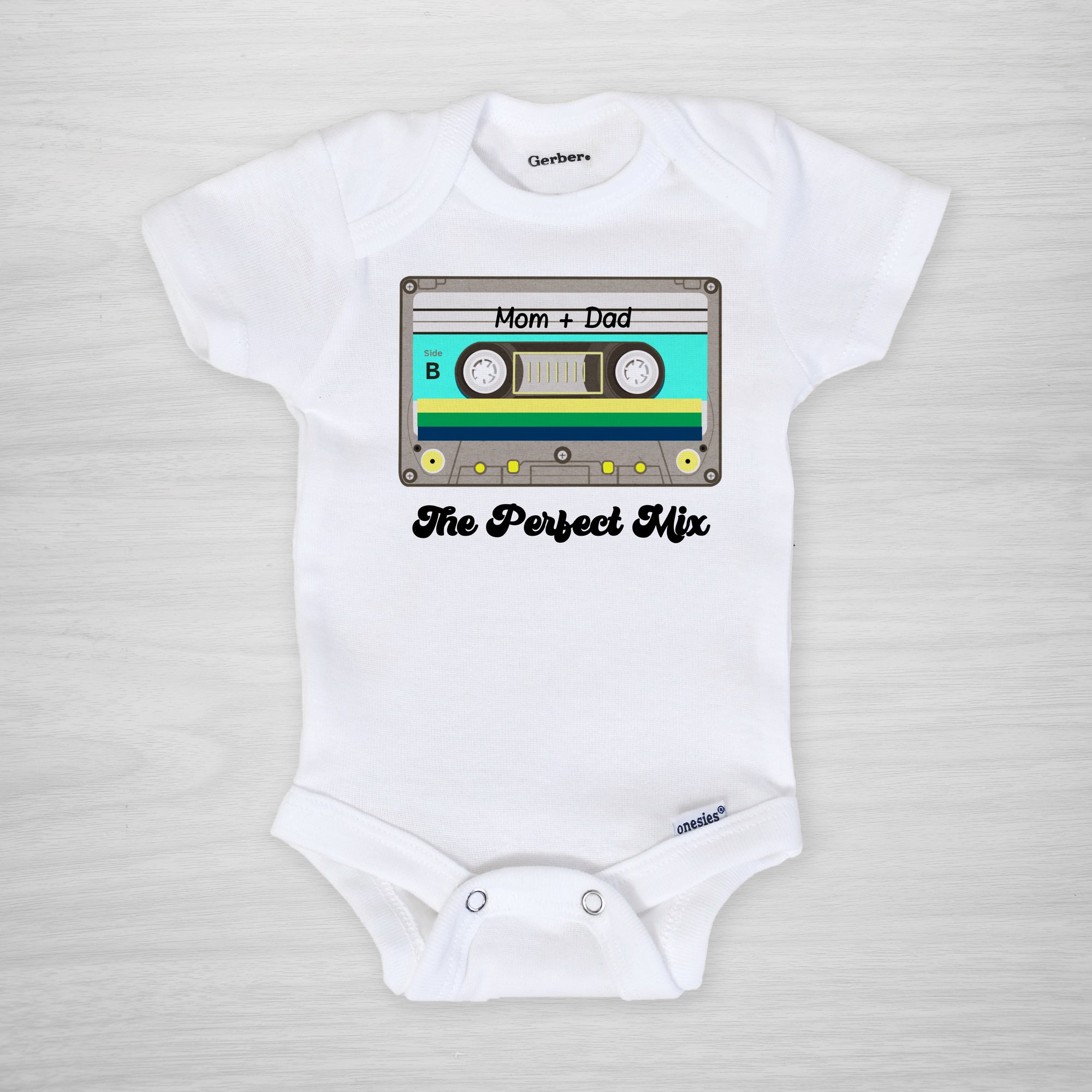 The Perfect Mix Onesie, featuring a retro 80s cassette mix tape with "mom + dad" written on it, custom printed in our Nashville studio on genuine Gerber Onesies, long sleeved