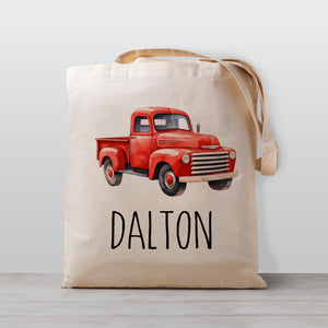 A red pickup truck on a personalized tote bag, perfect for carrying your little one's stuff to kindergarten, or bringing favorite books over to Grandma's house. 