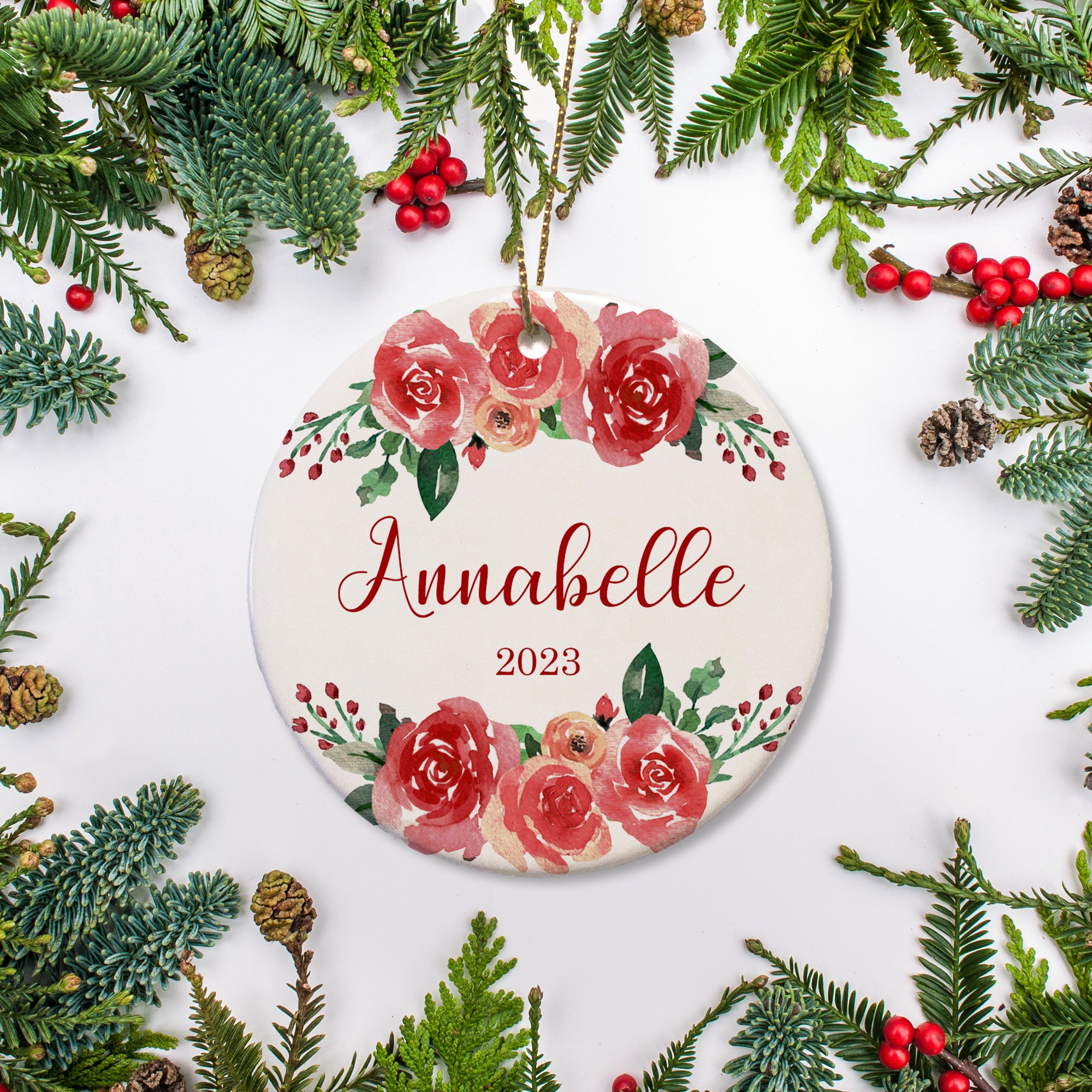 Red roses surround the name and year on this keepsake ornament.