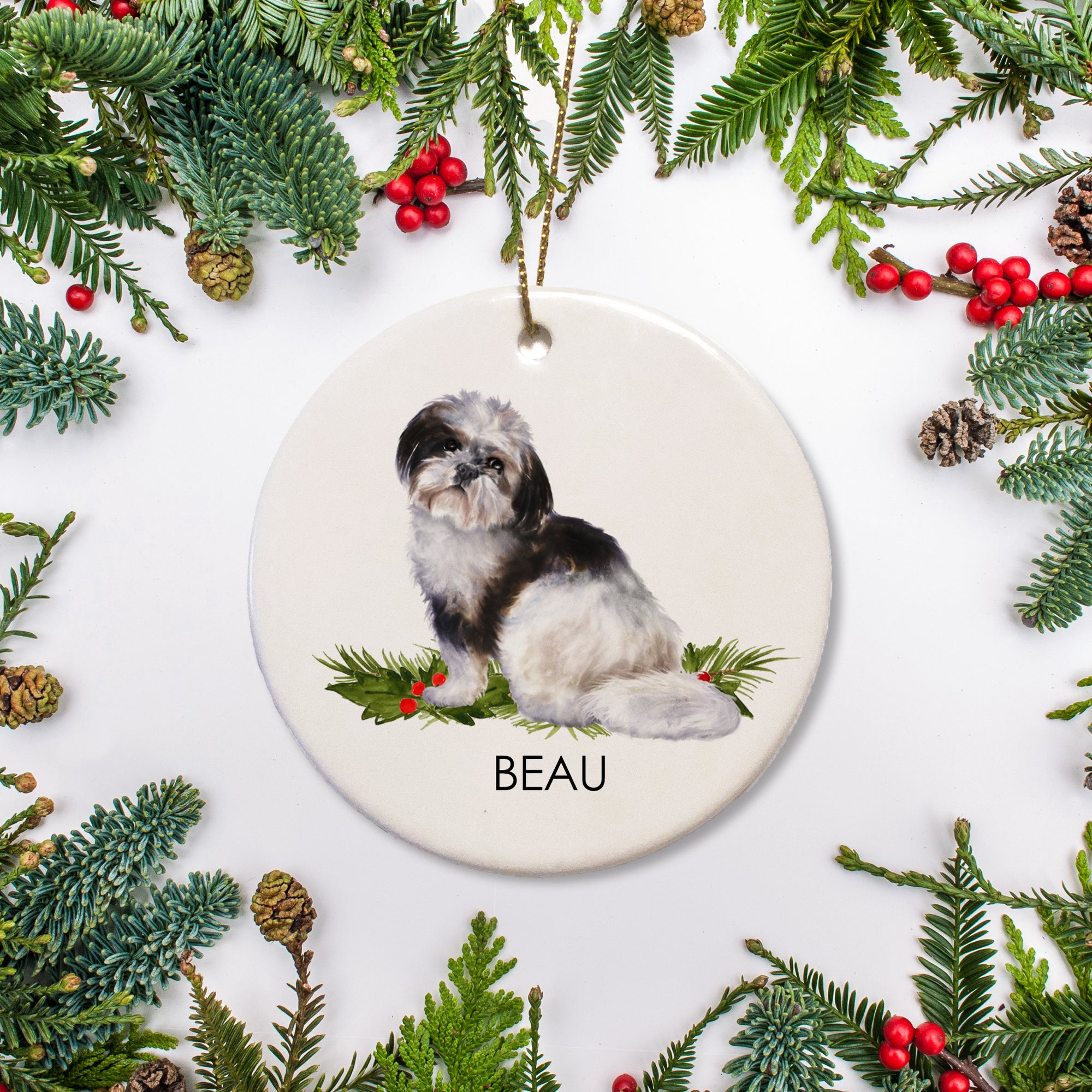 Personalized Shih Tzu Christmas ornament, featuring a black and white dog on a bed of holly, ceramic ornament with a gold hanging string