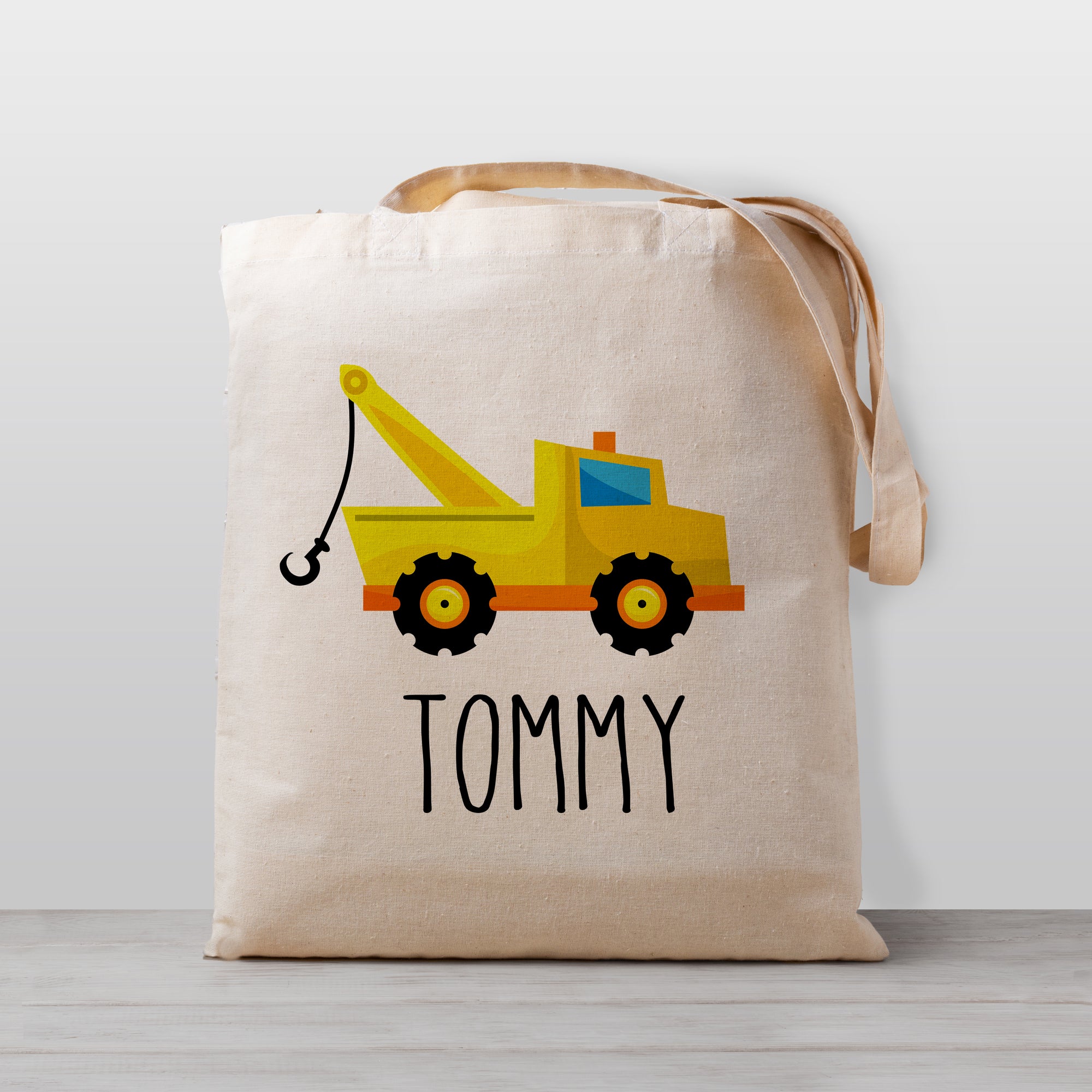A tow truck personalized tote bag, perfect for carrying your little one's stuff to preschool or kindergarten. Works great as a library book bag or to haul toys, too! 