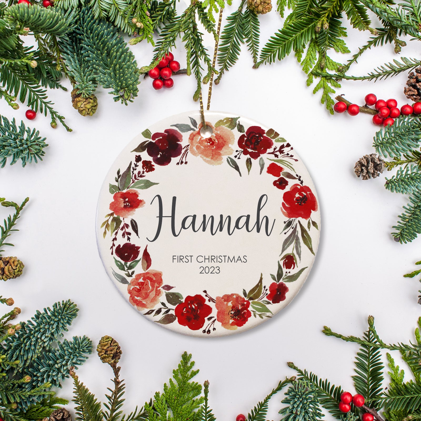 Personalized Christmas Ornament with name and year of your choice for baby's first Christmas, surrounded by olive wreath with blossom flowers throughout. | PIPSY.COM
