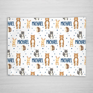 Fleece Blanket with forest animal pattern and personalized with your child's name. Features a bear, bunny, raccoon, and hedgehog