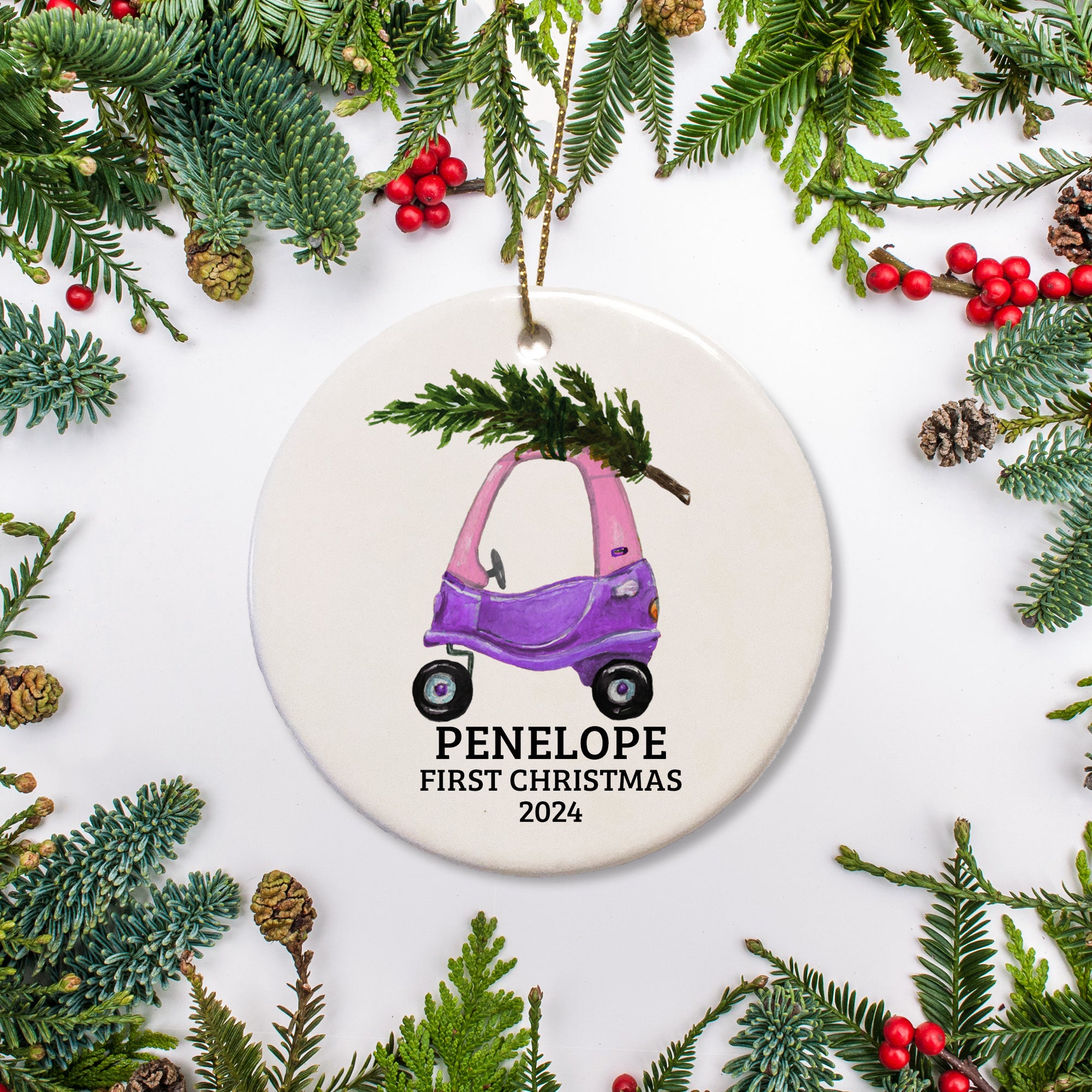 A toddler's  pink and purple car personalized on a ceramic ornament with a Christmas tree. This is a keepsake.