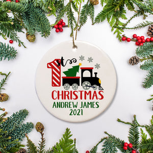 Baby's first Christmas Ornament - Personalized with name and year of your choice.  Black train carrying Christmas tree with red and white striped one.  Name and year in green text | PIPSY.COM