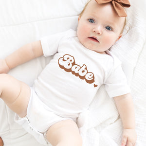Babe onesie with retro styling and neutral colors, Pipsy.com, short sleeved, model