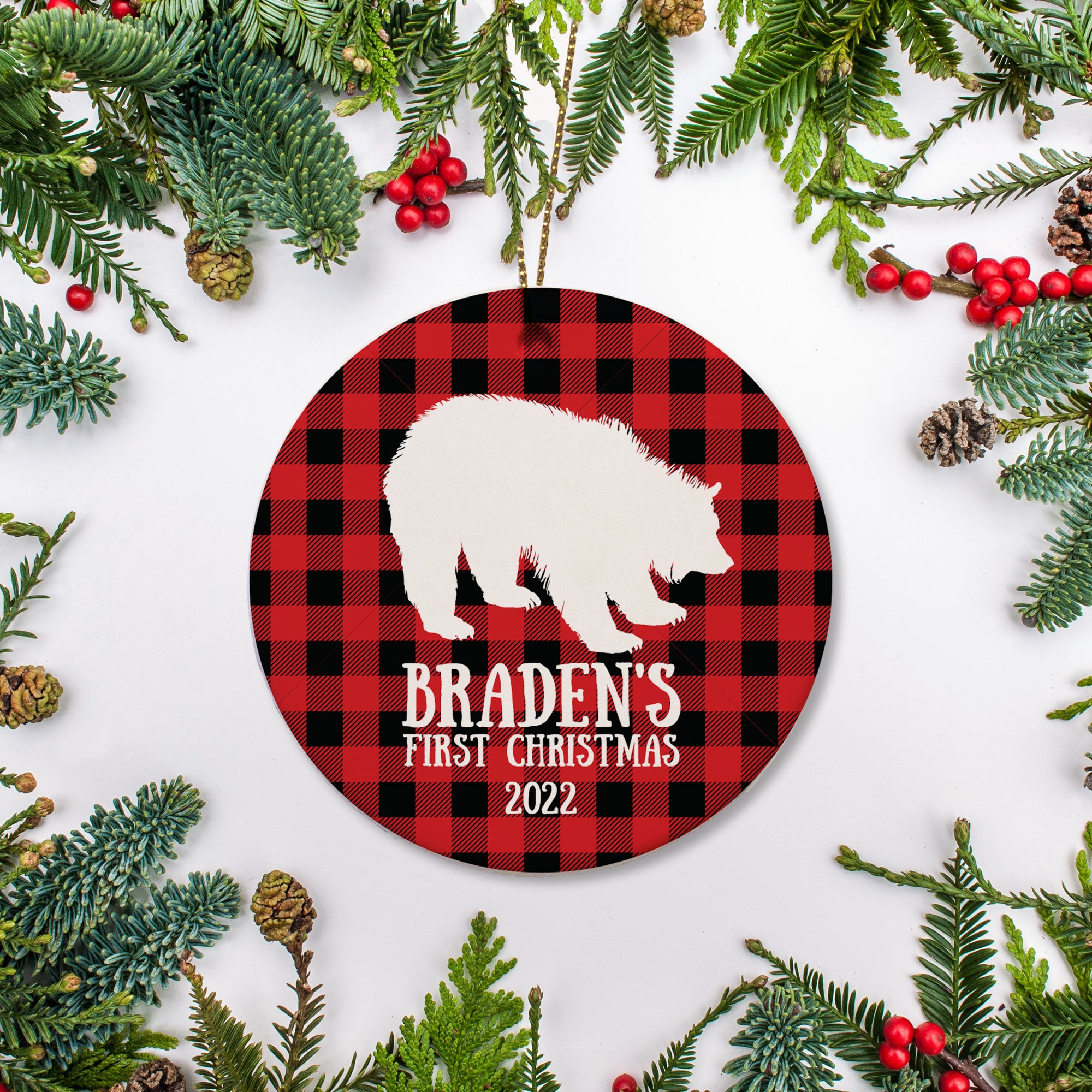 Personalized Christmas ornament featuring silhouette of bear on a red and black buffalo plaid. Child's name and year on the front with optional back text - Pipsy.com