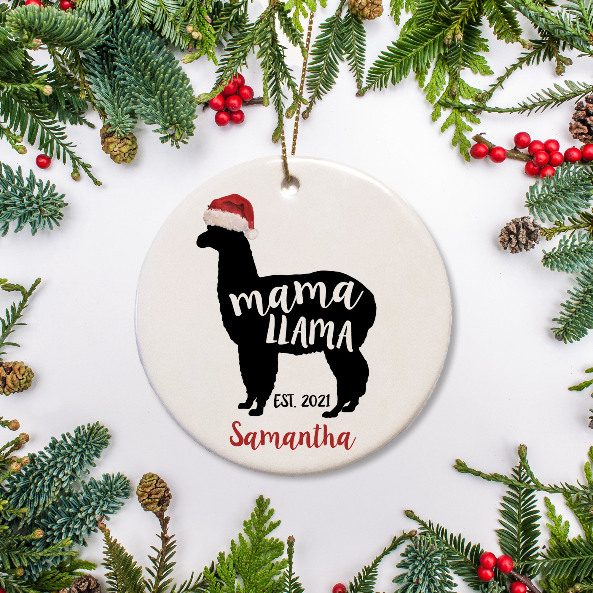 Black Silhouette of mama llama in Christmas hat. Marked with year mama llama is established and personalized with name in red. Round Christmas Ornament | PIPSY.COM