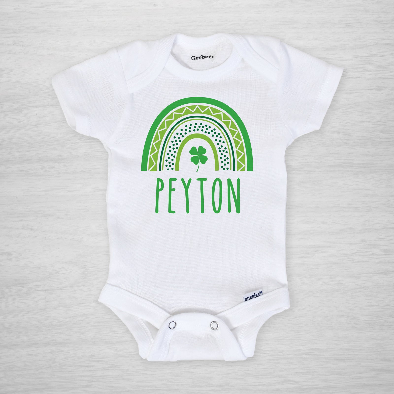 Personalized St. Patrick's Day Onesie® with a green modern rainbow and shamrock, short sleeved