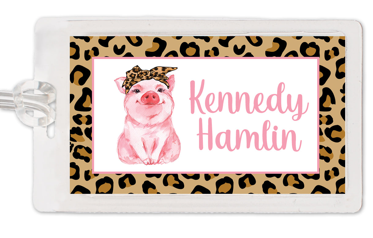 Cute personalized bag tag featuring a pig in a leopard headband. Perfect for your little ham! Laminated, two sided