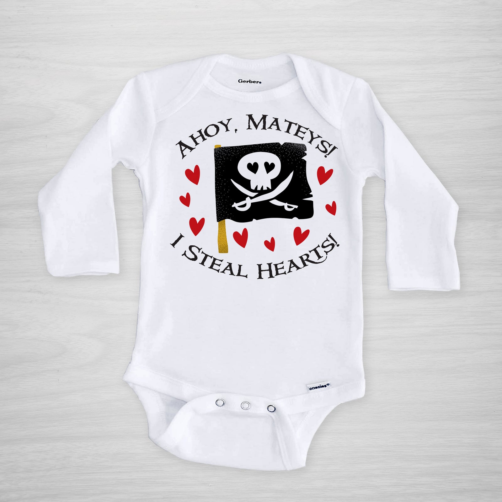 Pirate onesie for Valentine's Day. A cute pirate flag, with text that reads "Ahoy Mateys! I steal hearts!"  Printed on a genuine Gerber onesie® and hand pressed in Pipsy's Nashville studio, long sleeved