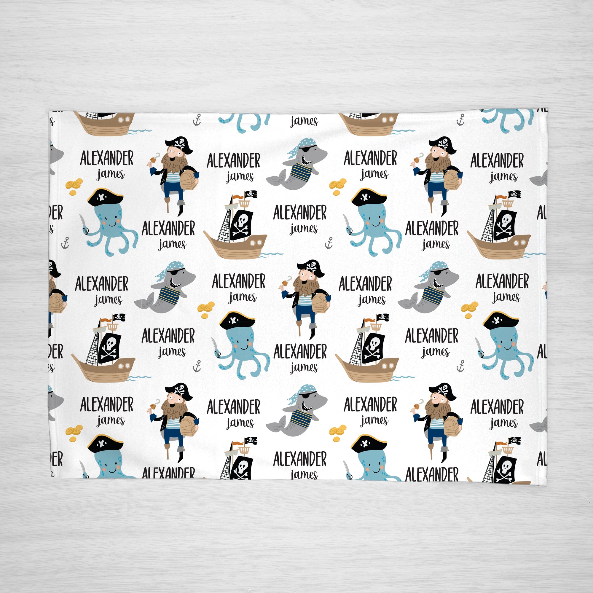 Pirate blanket personalized with your child's name, super soft fleece. features sea creatures like an octopus and shark, and also a pirate ship, full view