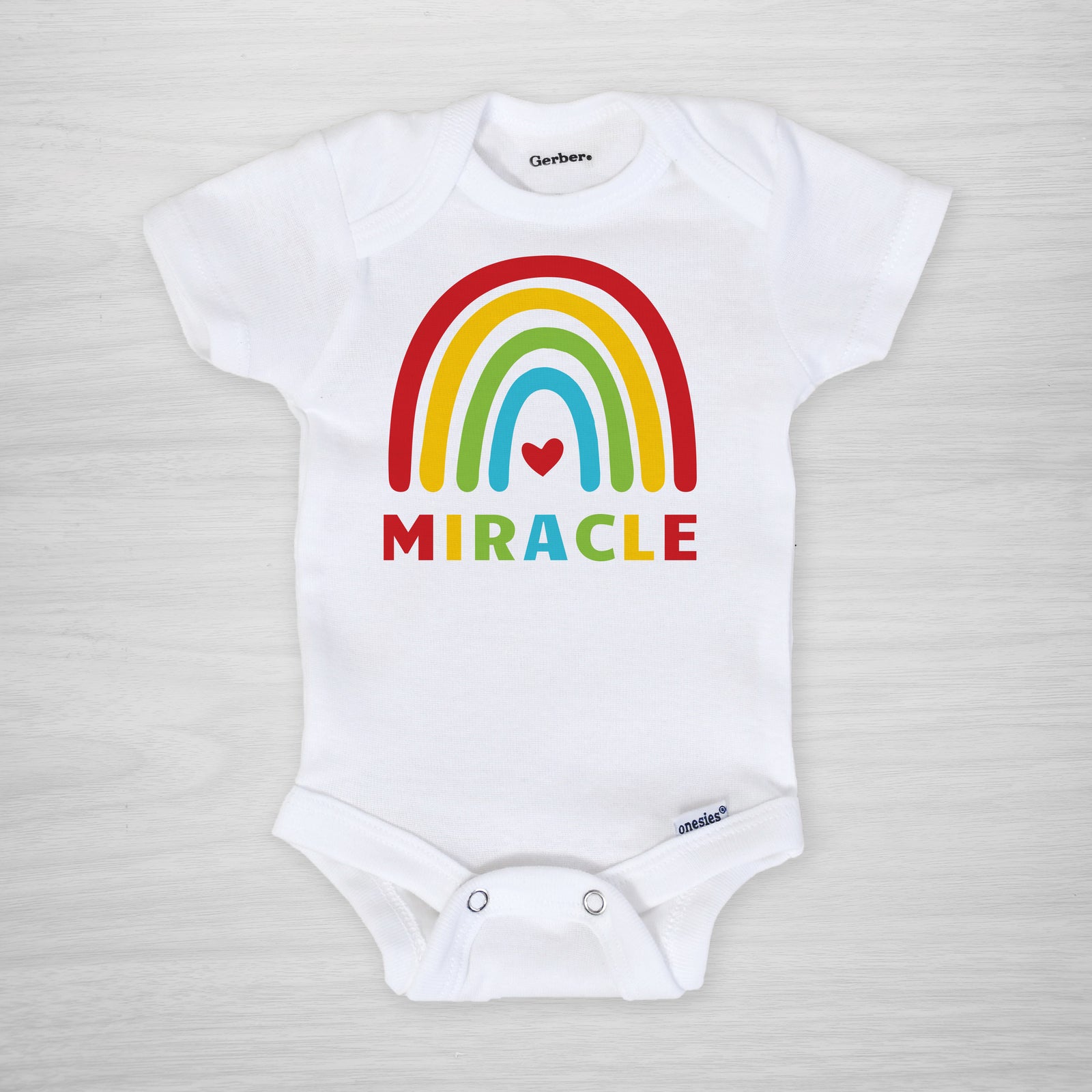 Miracle Rainbow Baby Onesie® in primary colors, long sleeved