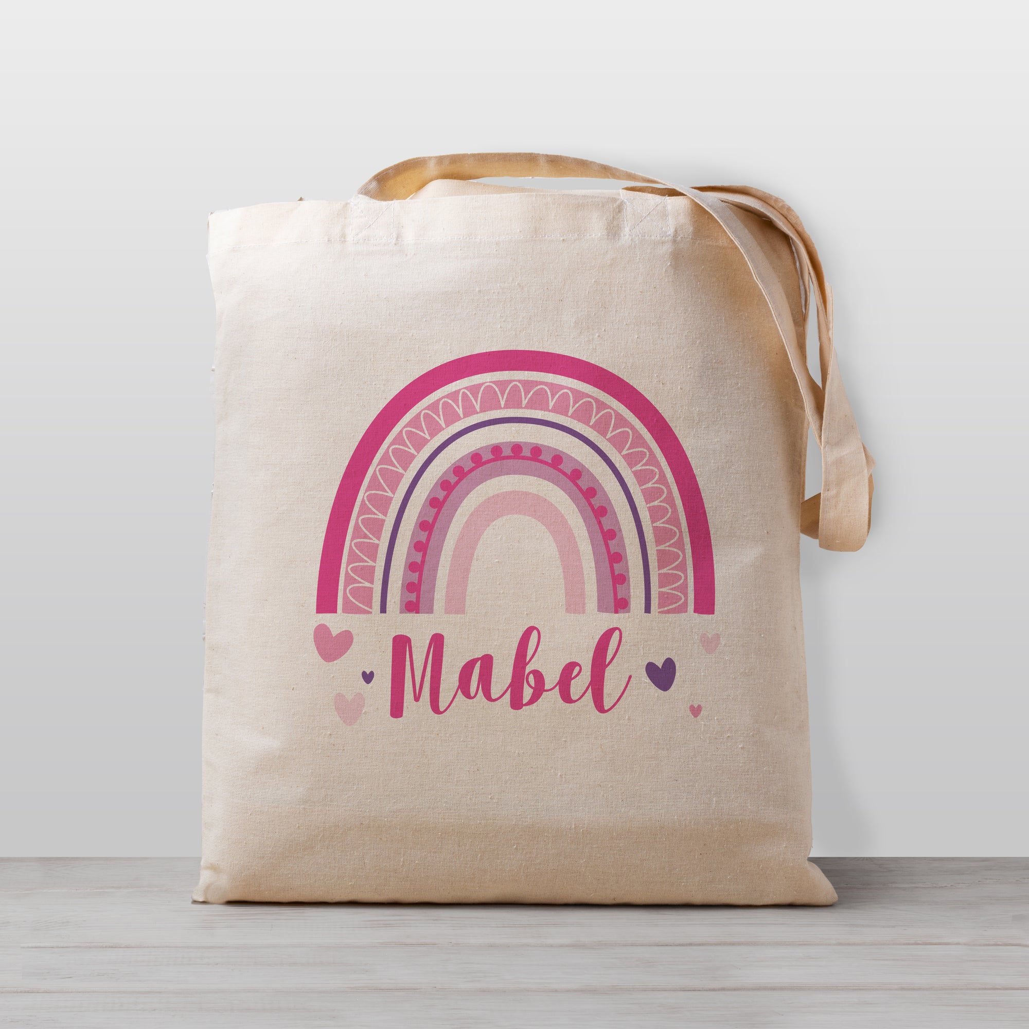Rainbow Personalized Girl Tote Bag with hearts and a whimsical design. Tote bags are 100% cotton and sized for a child to carry easily. Perfect for your preschool or daycare bag