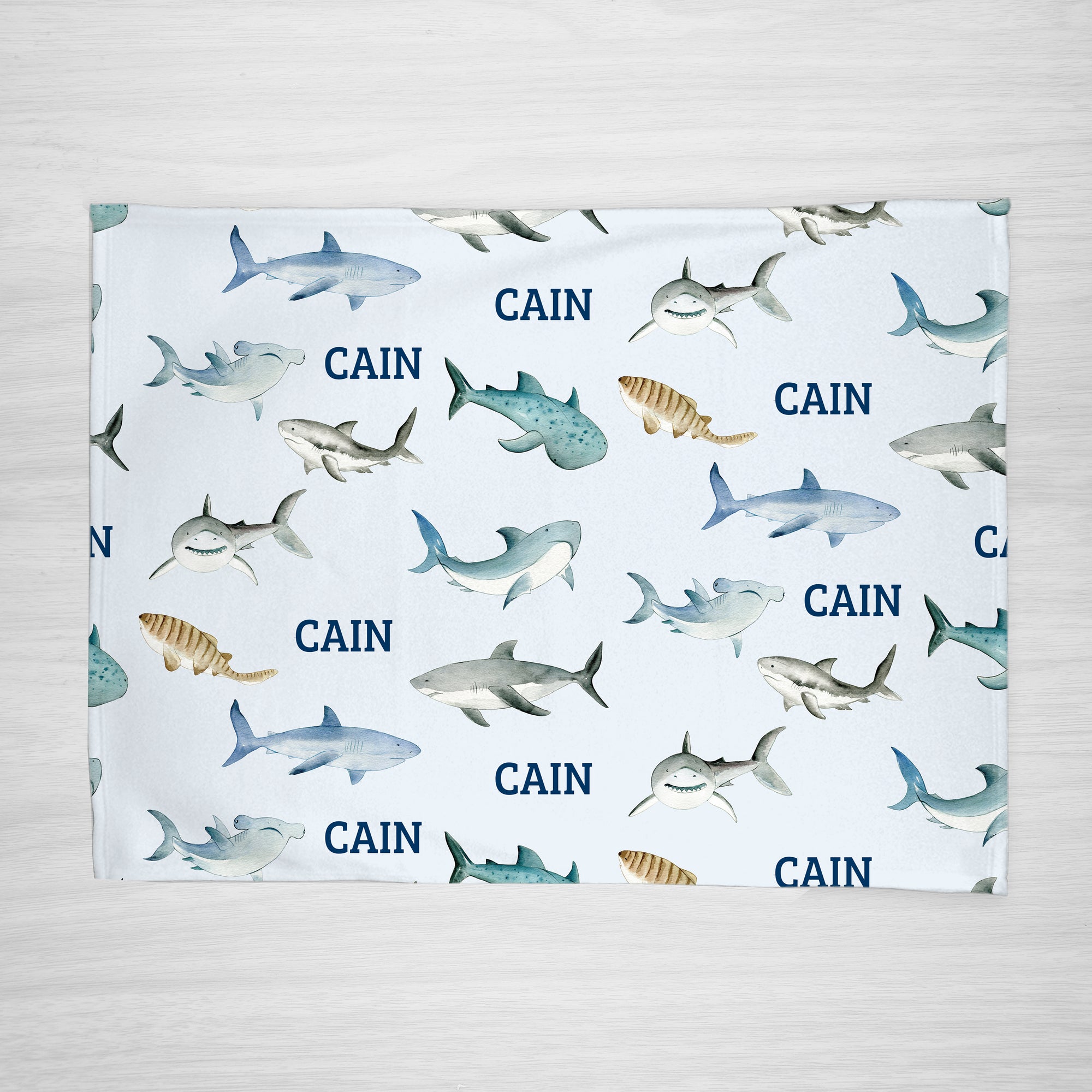 Our personalized shark blanket has your child's name and an assortment of sharks (tiger shark, hammer head shark, whale shark and more). Choose a smaller size for a stroller blanket, or one of our huge sherpa blankets for a snuggle blanket that will be loved for years.