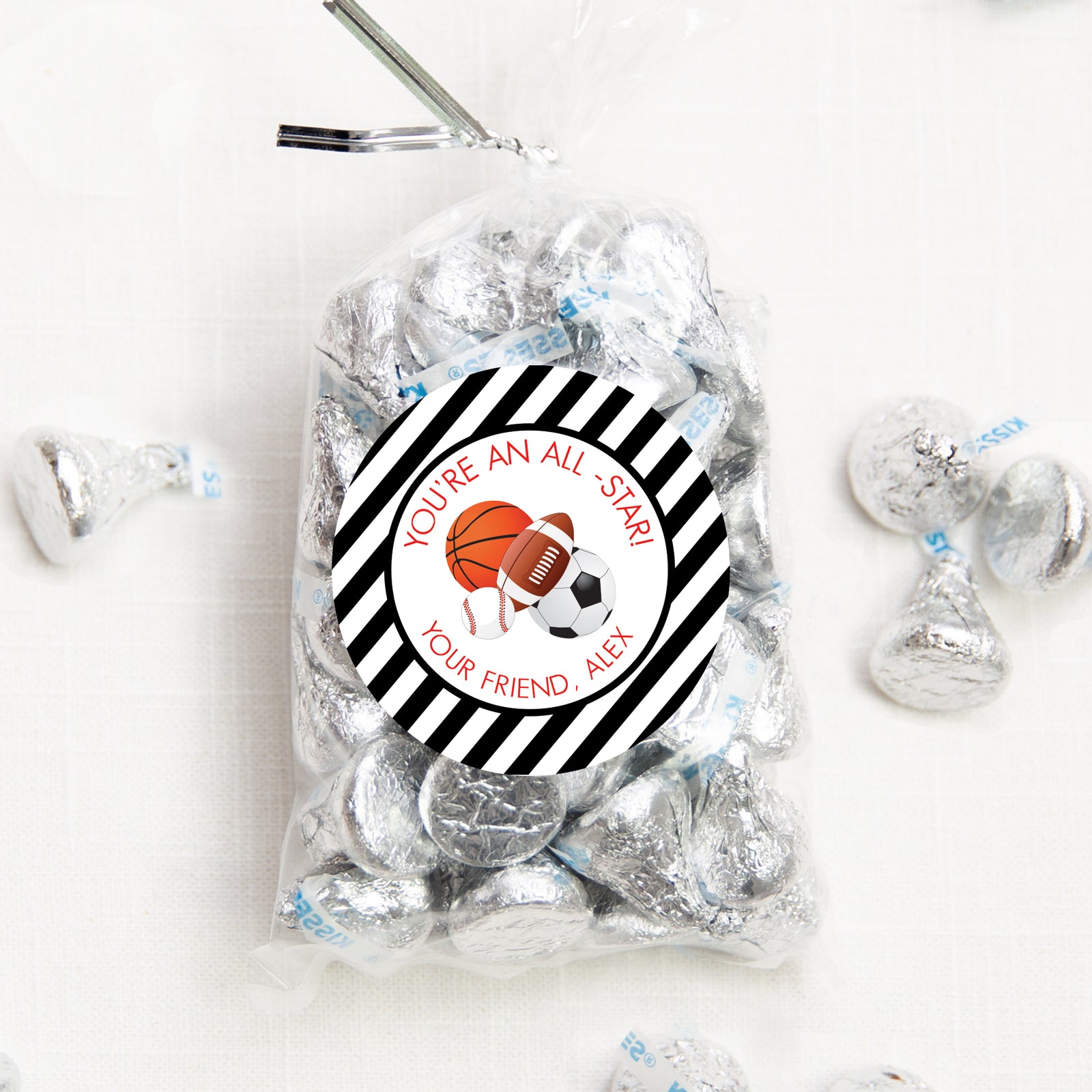 2.5 inch round sticker with basetball, baseball, soccer and football.  Personalized with a black and white striped border. Pipsy.com