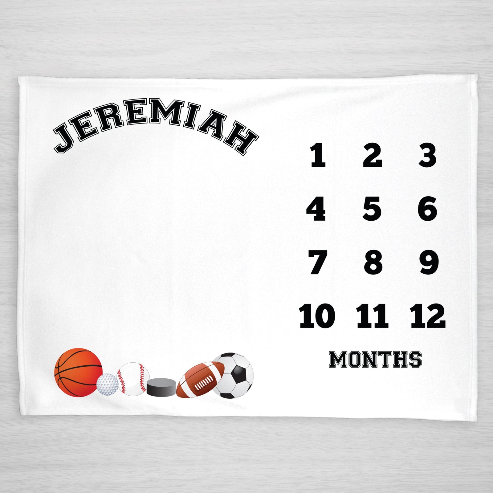 Sports Personalized Milestone Blanket, featuring a basketball, golf ball, baseball, hockey puck, football, and soccer ball