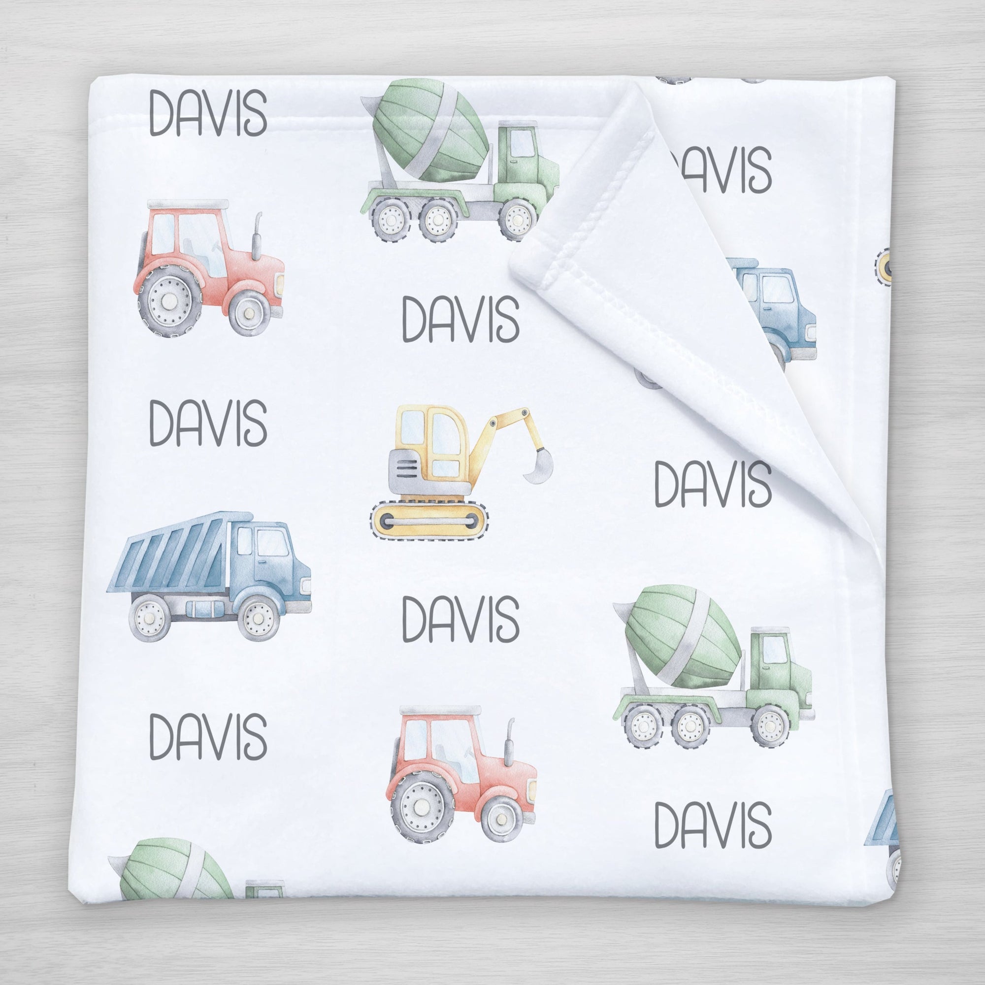 Truck Personalized Name Blanket, 100% fleece, featuring a backhoe, tractor, cement mixer, and dump truck