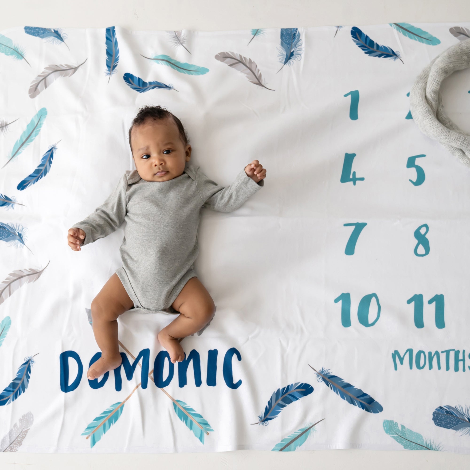 Feather And Arrows Boy Milestone Blanket in shades of blue and gray. Personalized with baby's name