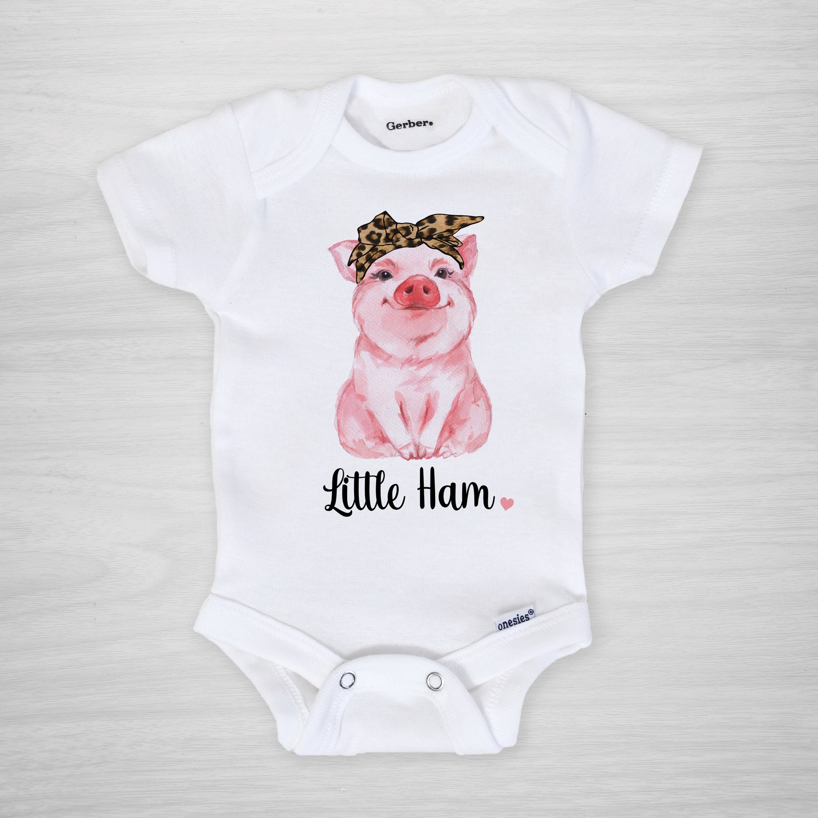 Little Ham Onesie - A cute pig with a cheetah leopard headband printed on a genuine Gerber onesie®, short sleeved