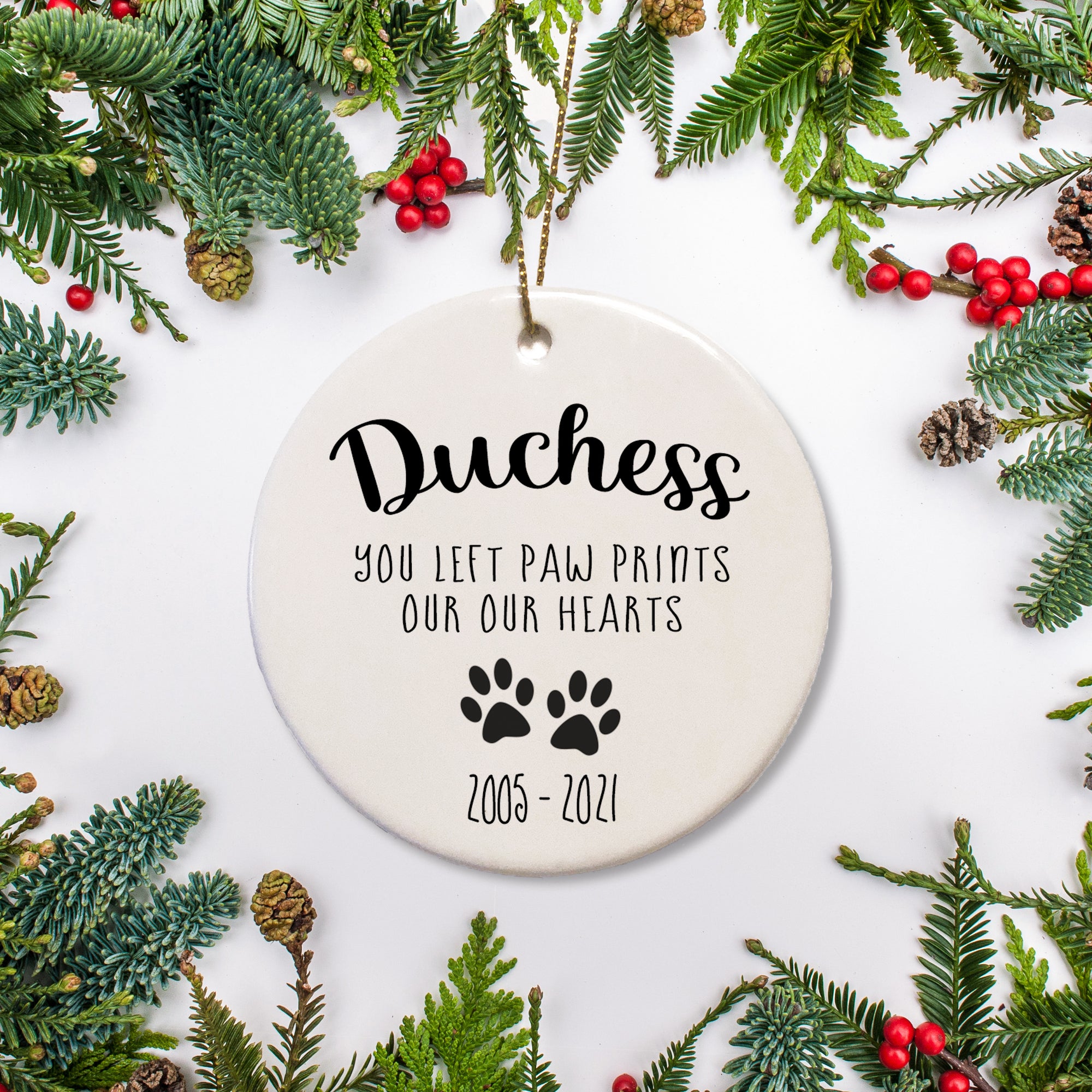 You left footprints on our hearts -Personalized Christmas Ornament. Pet remembrance Name arched across the top and paw prints and years of life on the bottom - Pet memorial gift, keepsake for your pet | PIPSY.COM