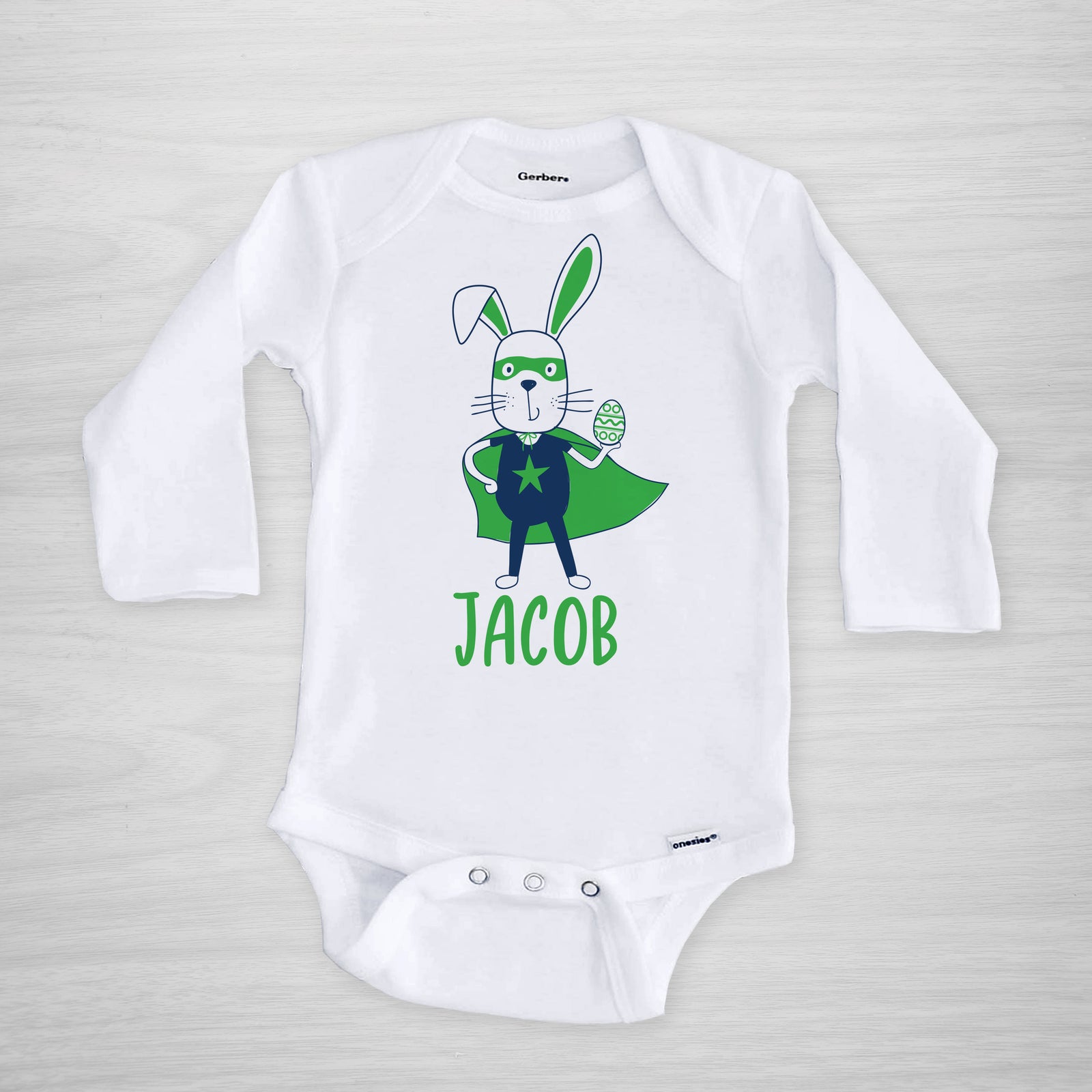 Superhero Easter Bunny with a cape, mask, and egg on this personalized Gerber Onesie®, short sleeved blue