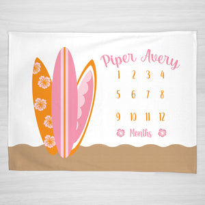 Surfer Personalized Baby Milestone Blanket, Pink and orange surfboards resting on a sand beach, with hibiscus flower accents, girl